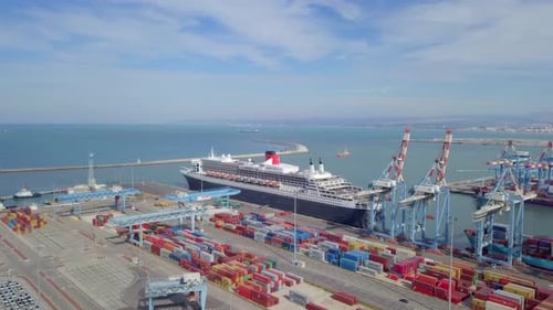 Queen Mary 2 luxury cruise ship docked at port - Aerial footage.