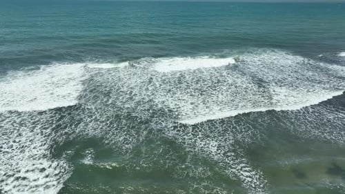 Aerial View of Ocean Waves with White Foam