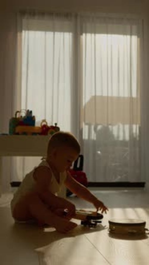 Infant plays with toys on floor at home