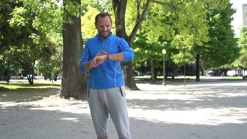 Man Setting Smartwatch for Distance and Start Jogging in City Park, Super