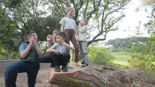 Happy Children Celebrating Clapping Hands in a Sunny Park