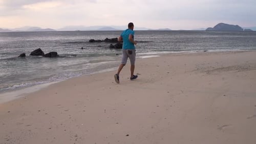 Young Man Jogging on Beach During Sunset, Super 120