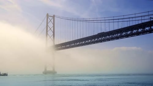 Timelapse of April 25Th Bridge in Fog Over Tagus River Lisbon Portugal on Sunny Day