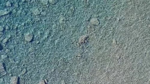 Aerial Drone Top Down View Reflection Texture in Shallow Ocean Water Rocks Sand