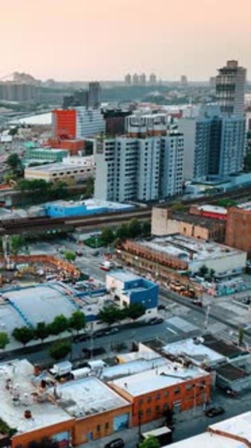 Construction site near the railways and busy roads. New York cityscape from top perspective
