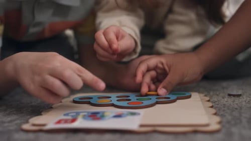 Children Playing a Colorful Wooden Puzzle Together