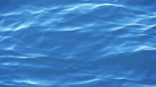 Blue Ocean Water Ripples and Reflects Sunlight