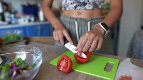 Woman Prepares Healthy Salad with Fresh Tomatoes