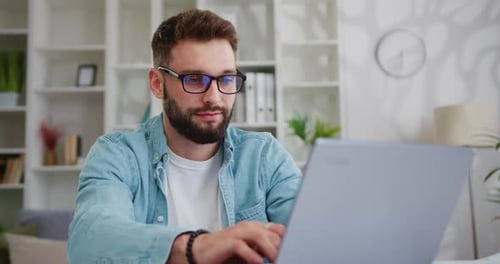 Man working on laptop computer at home