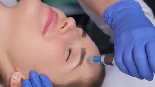 Professional Cosmetologist Performs DermaPen Procedure in a Cosmetology Clinic Vertical Video