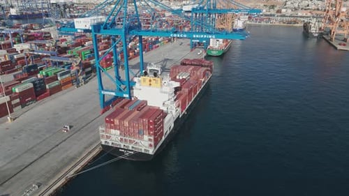 Aerial View of a Port Container Terminal with Cranes Loading a Ship