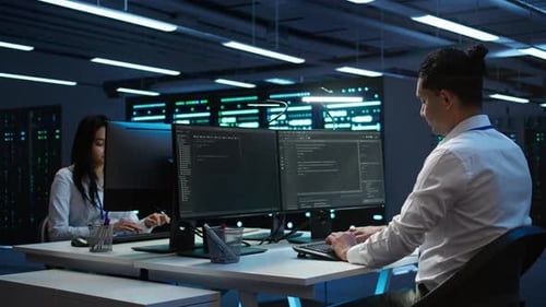 Portrait of Cheerful Engineer in Data Center Installing Software on Computer