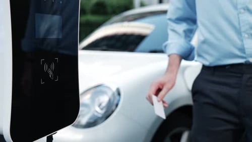 Progressive Man Pay for Charging Point to Power Rechargeable Electric Vehicle