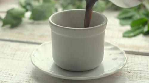 Dark Brewed Coffee Poured in White Cup