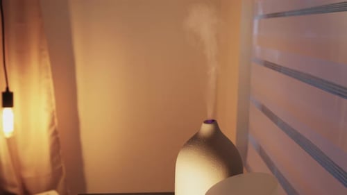 Aroma Diffuser Releasing Vapor in Softly Lit Room