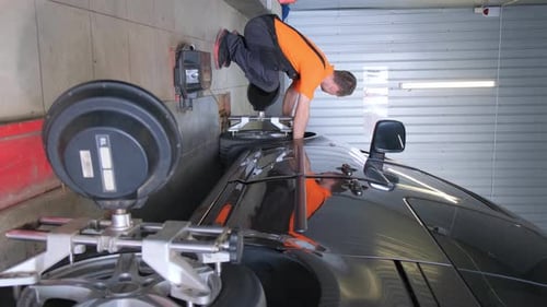 Das Auto steht auf einem Ständer zum Einstellen von Autorädern in einer Autowerkstatt Vertikales Video