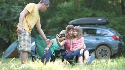 Family Poses for Selfie at Campsite