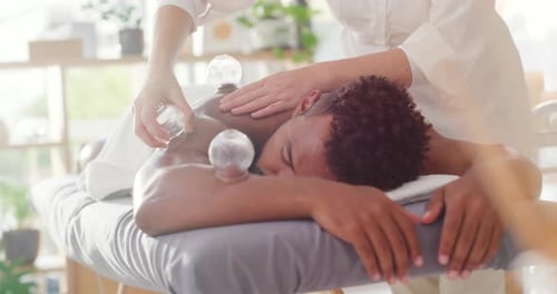 Massage Therapist Giving Cupping Massage to Young Adult