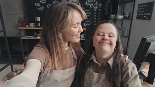 Smiling Women Pose Together in Cafe