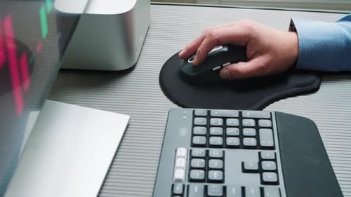 A Businessman's Hand Uses a Computer Mouse