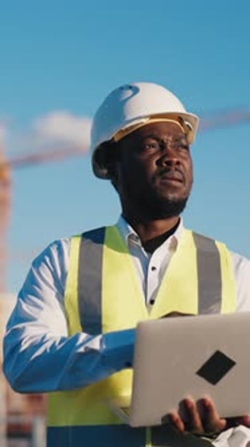 Architect on Construction Site Vertical Portrait of Professional with Modern Laptop Controlling