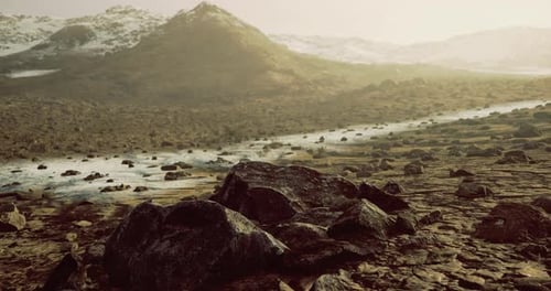Serene Morning Light Over Rocky Landscape with Distant Mountains