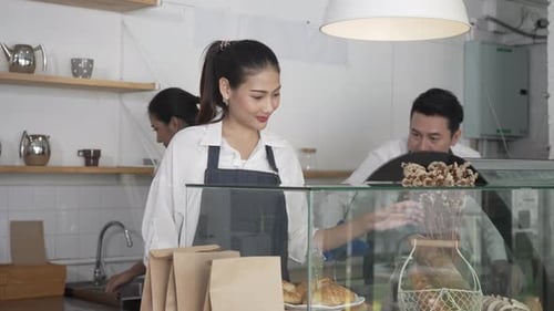 Entrepreneur and team are working at bakery and coffee shop.