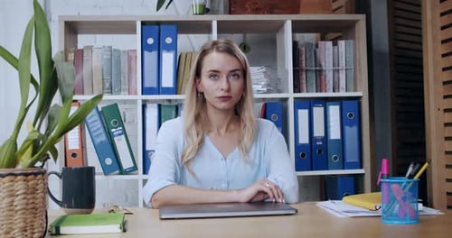 Confident Young Business Woman with Strong Look Sitting in Corporate Office Portrait of Ambitious