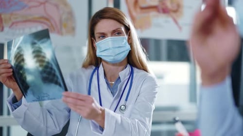 Doctor with X-ray discussing results with patient