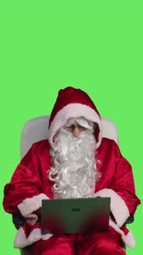 Vertical Video Front View of Trendy Father Christmas on Laptop