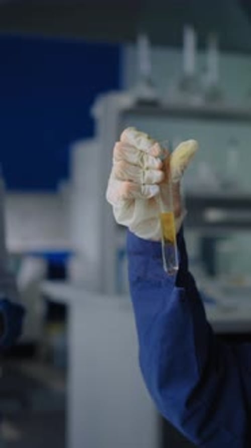 Medical Professional Holding Test Tube in Lab Close Up