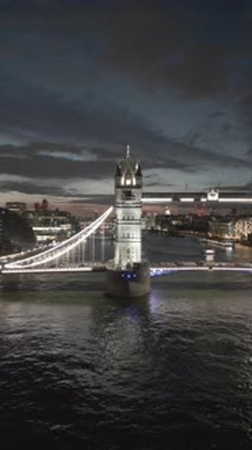 Aerial video of the city of London and the lighthouse bridge in London at night