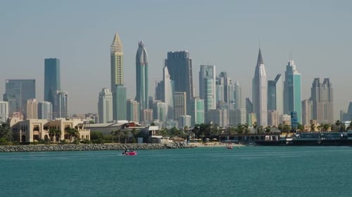 Nikki Beach Dubai On The Waterfront Of Palm Jumeira With Scenic View Of City Skyline In Summer. wide