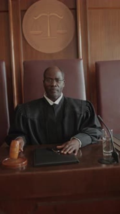 Judge Sits at the Bench in Courtroom