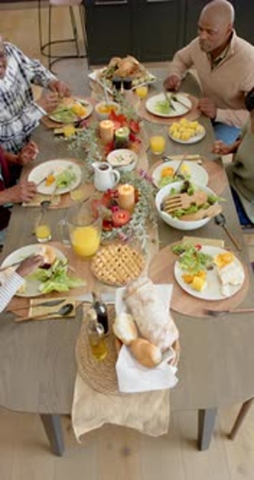 Overhead Shot of Family Dining at Long Table