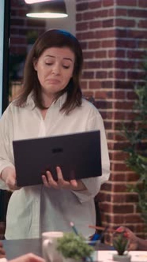 Woman Presents Data to Team in Modern Office