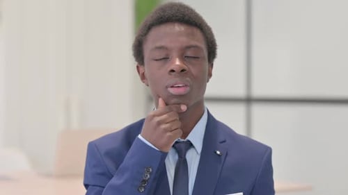 Young Adult Businessman Thinking, then Raising Finger