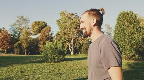 Loving Couple Embracing and Kissing in a Green Park