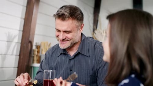 Man and Girl Eating Together Indoors