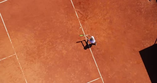 Aerial Top View of a Young Female Tennis Player Playing on Brown Ground Court