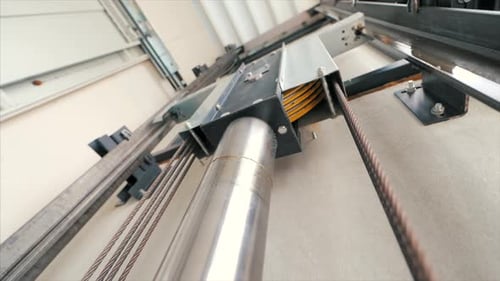 Elevator lift cabin moves up inside illuminated elevator shaft with hydraulics with many floors slow