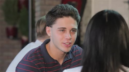 Close Up of a Young Man Enjoying a Drink at the Bar