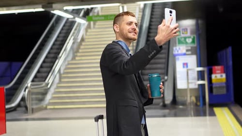 Businessman taking selfie in subway station