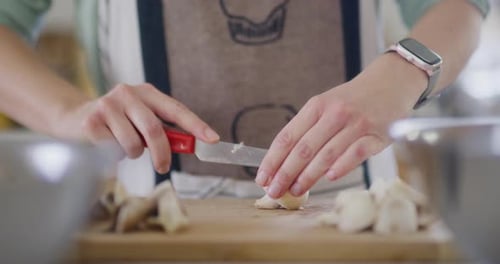 Woman Chopping Fresh Mushrooms in a Kitchen