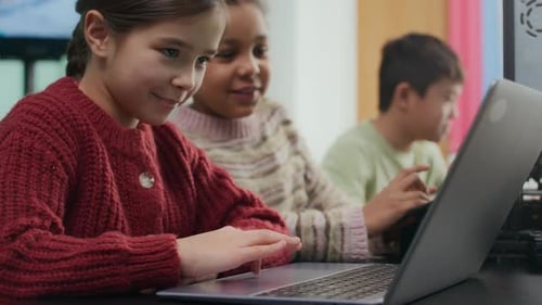 Girls Learning Technology on Laptop Computer in Classroom