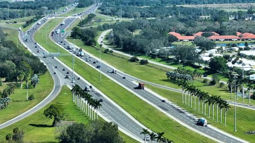 Aerial View of Freeway Overpass Junction with Fast Moving Traffic Cars and Trucks in American Rural