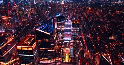 Lively shining New York at night. City scenery above the skyscrapers tops in metropolis downtown.