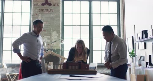 In Modern, Industrial Office, Group Of Architects Discuss A Scale Model And Collaborate On Urban ...