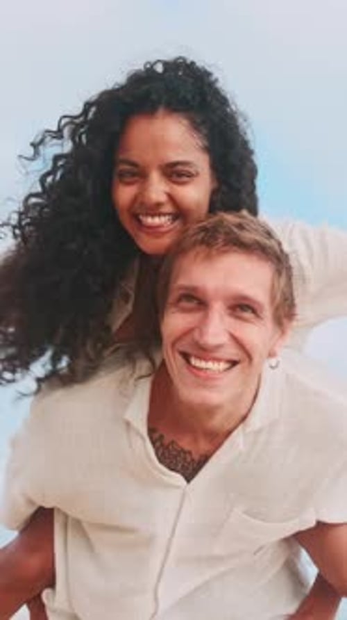 Couple Enjoys a Joyful Moment By the Beach at Sunset