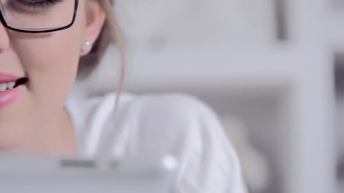 Smiling woman using tablet for work or leisure
